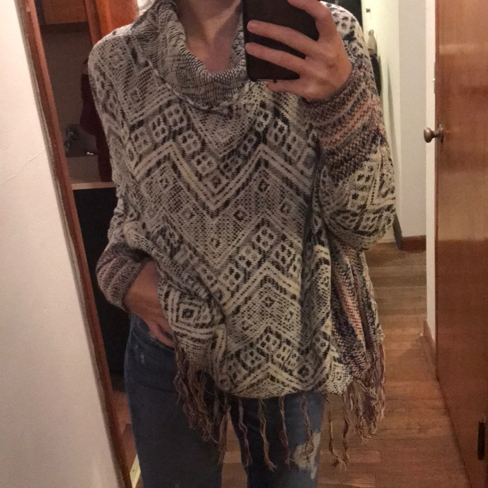 A multicolored, patterned cowl neck sweater